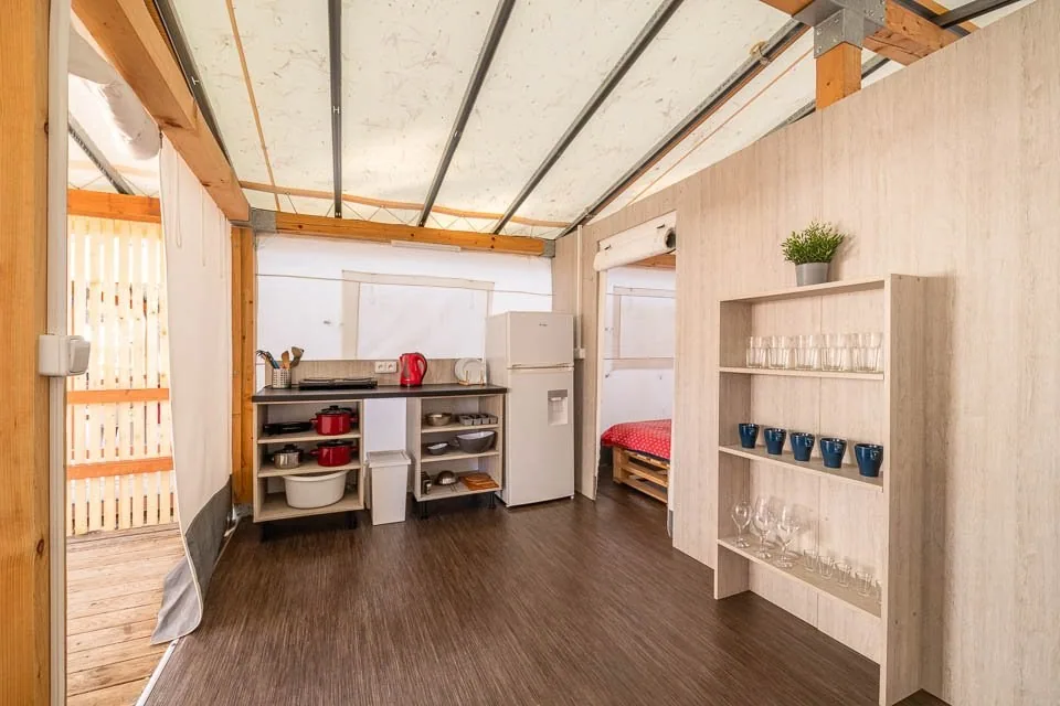 Equipped kitchenette and wooden interior of a Glamping CLASSIC tent at Camp Čikat