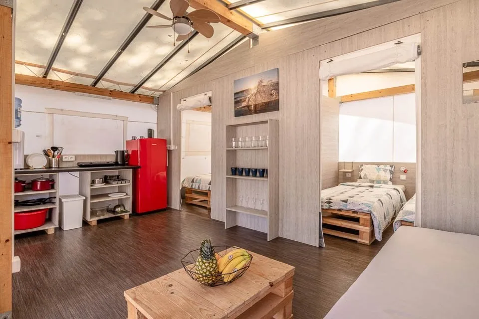 Kitchenette, ceiling fan and bedroom doorway inside a Glamping PLUS tent at Camp Čikat
