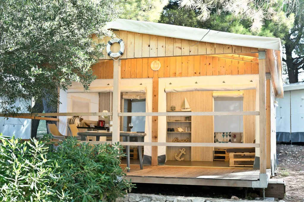 Glamping CLASSIC safari tent with a covered terrace among trees at Camp Adriatic near Primošten